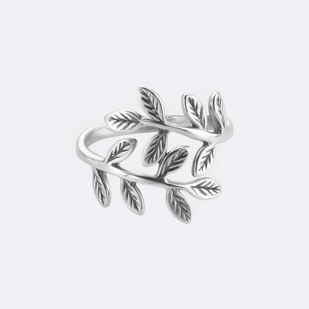 Silver adjustable olive leaf ring with two leafy branches wrapping the band